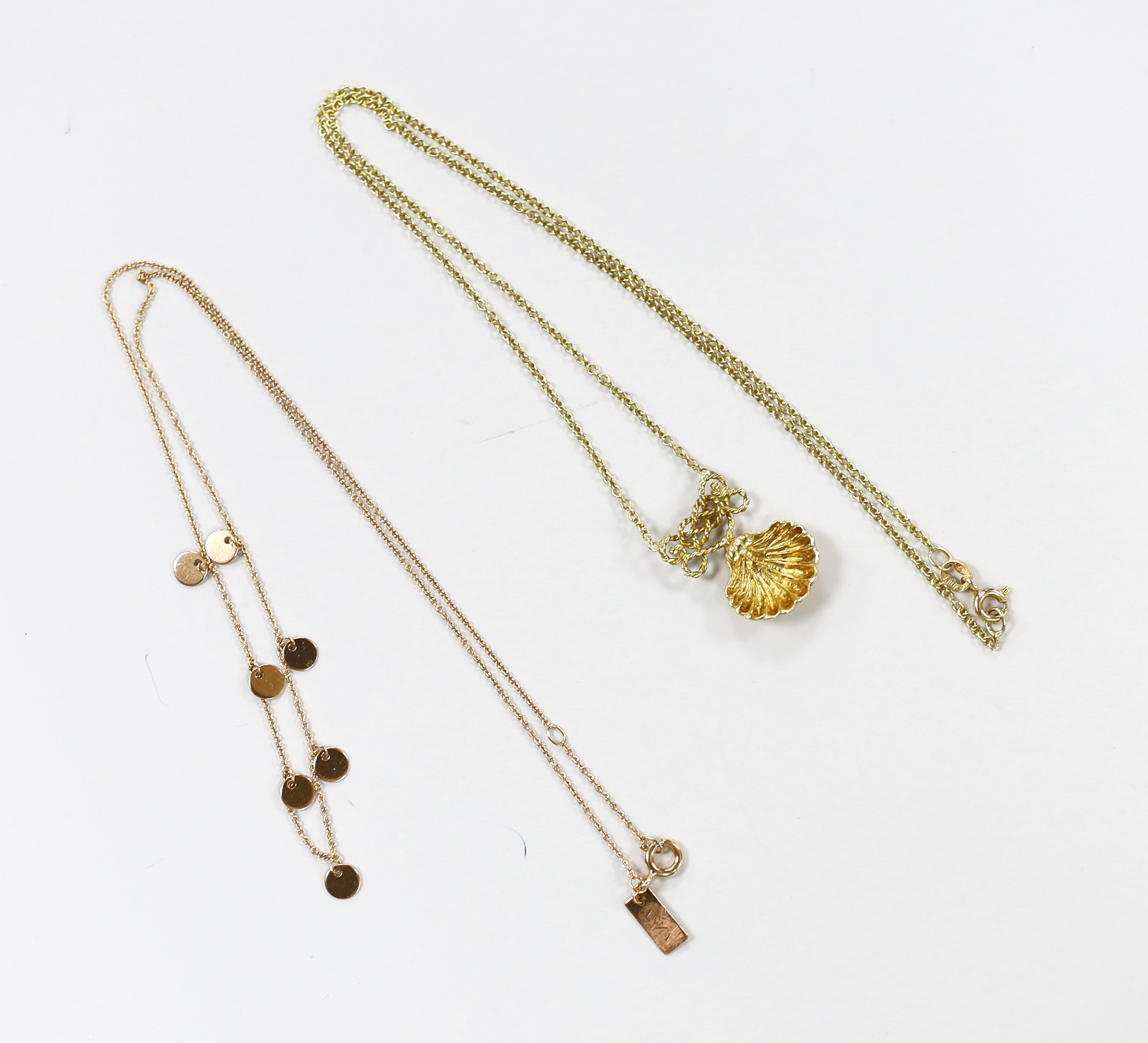 A modern Anna 750 yellow metal necklace, hung with seven small discs, 38cm and a modern Italian 18ct gold shell pendant necklace, 44cm, gross 7.9 grams.